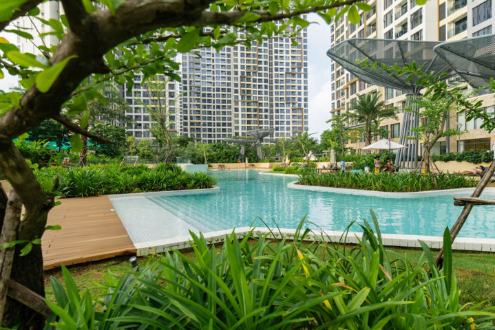A pool in a park with trees and plantsAI-generated content may be incorrect.